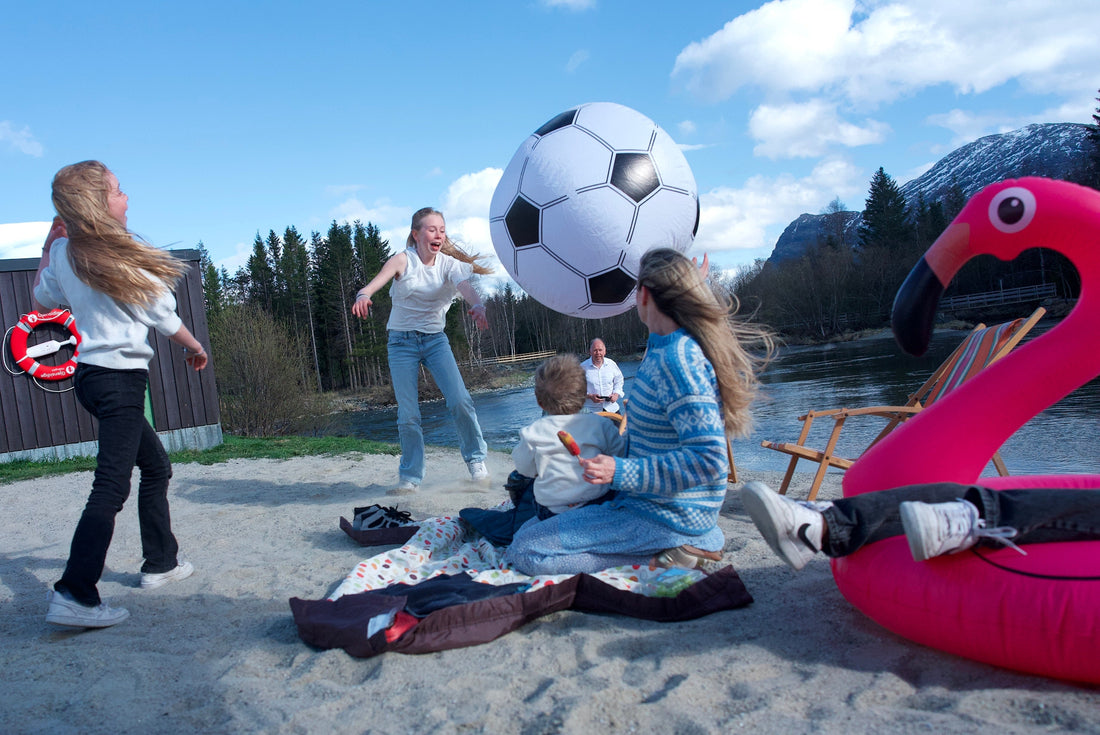 Fun family playing with giant inflatable ball at the beach with the help of Hedgehog TurboVAC