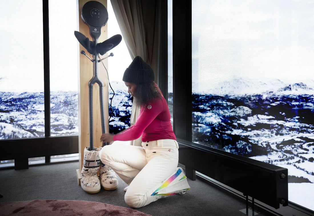 Woman dries snowboard boots on Hedgehog Buddy gear dryer
